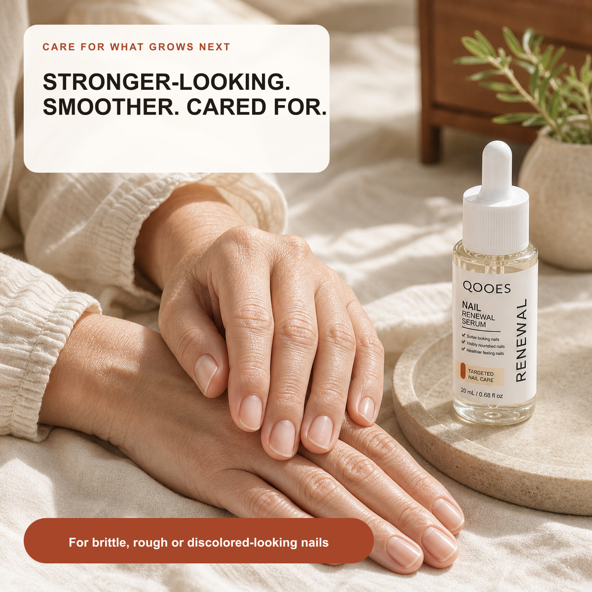 Mature woman showing smooth well cared for natural nails with QOOES serum