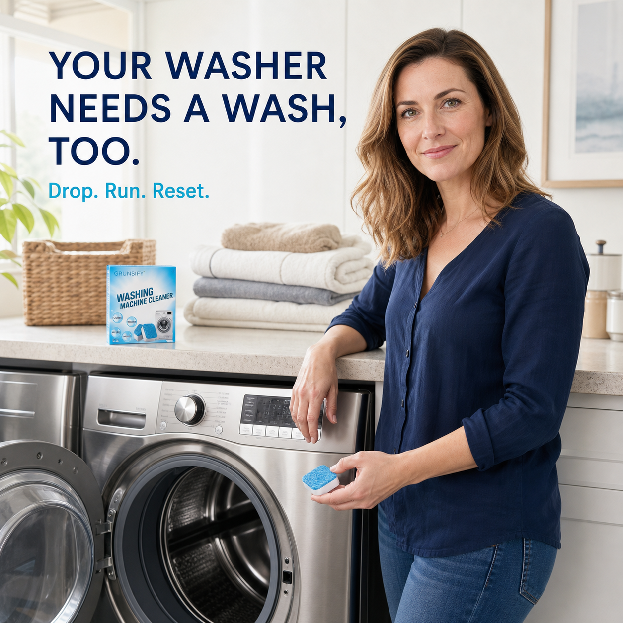 Woman holding a GRUNSIFY washing machine cleaner tablet beside an empty front-load washer