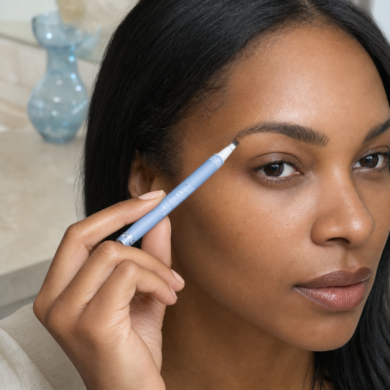 Black woman applying ALISANDA Brow Architect Duo